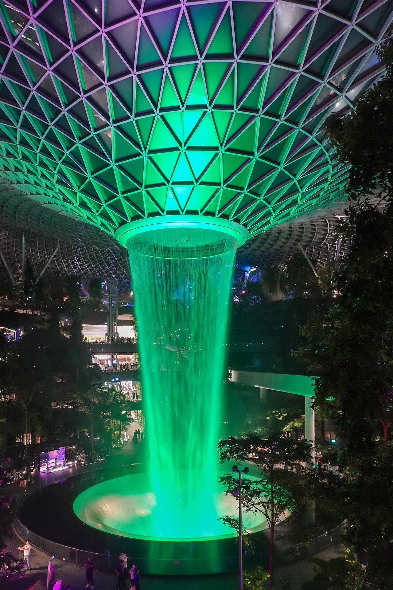 The Rain Vortex inside Jewel Changi lit up at night